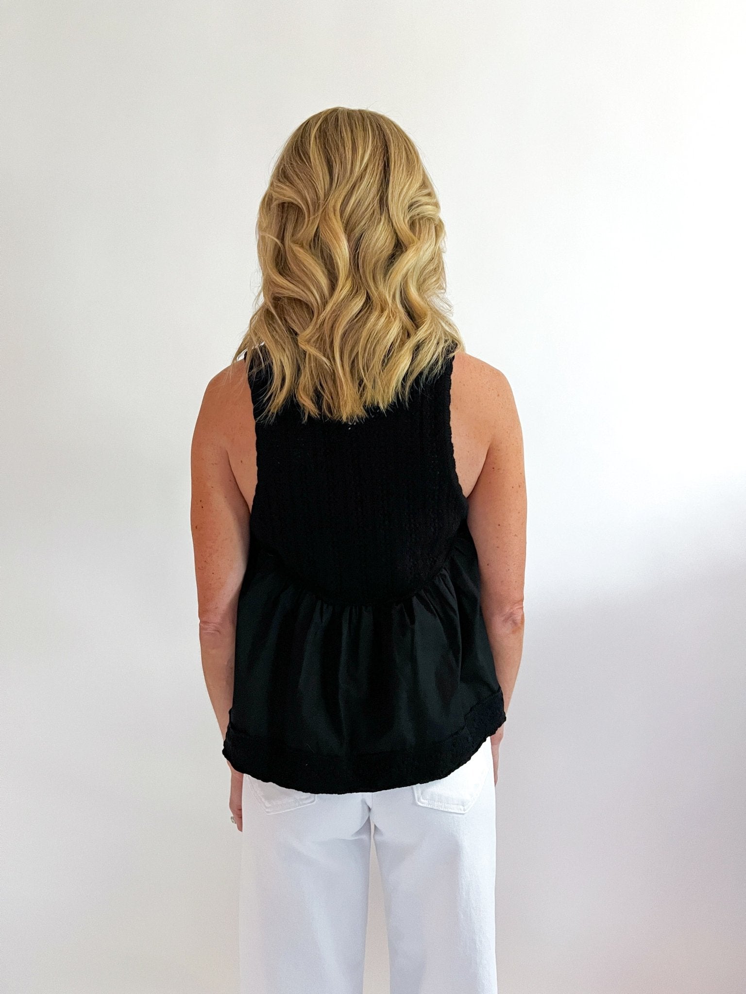 Black pointelle knit top with collared button-down neckline