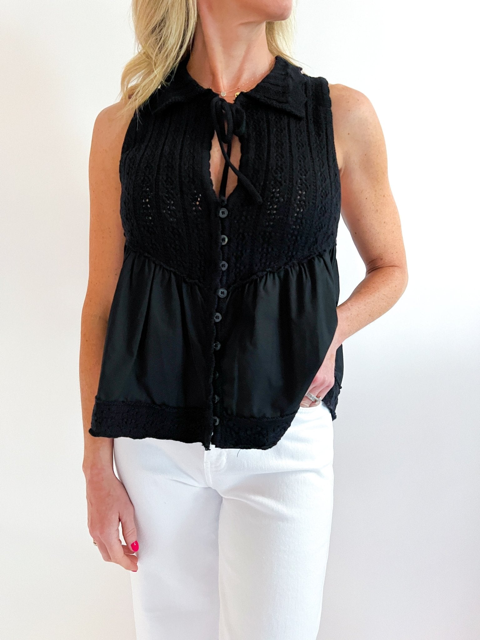Black pointelle knit top with collared button-down neckline