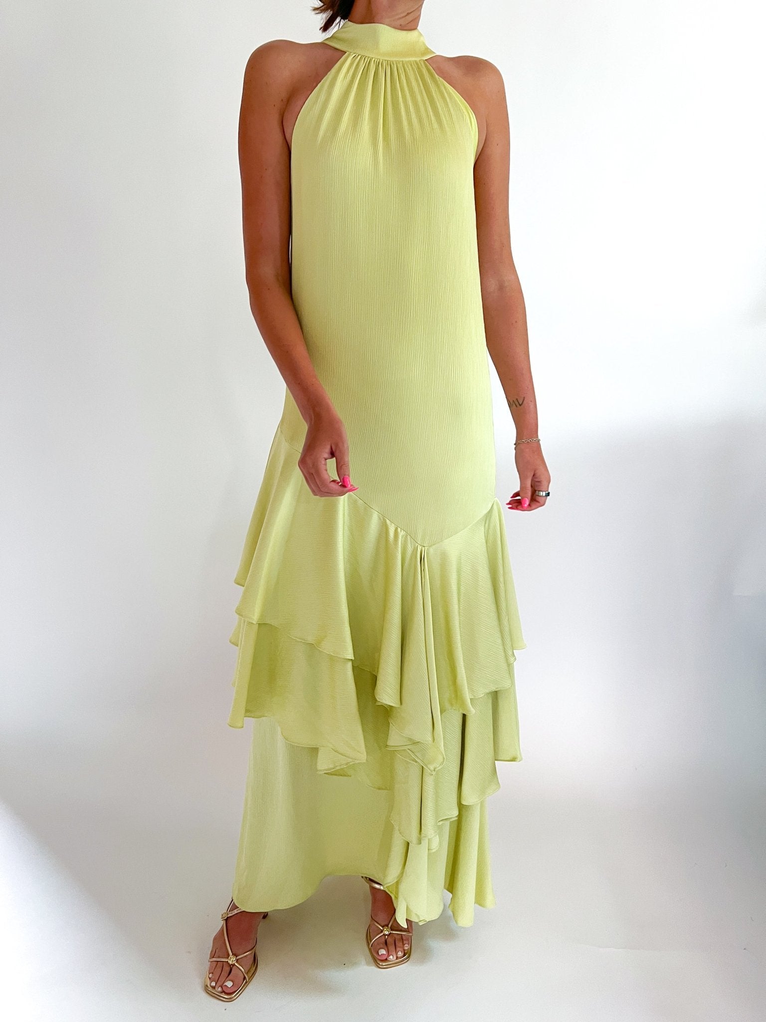 Pistachio green halter maxi gown with elegant formal silhouette