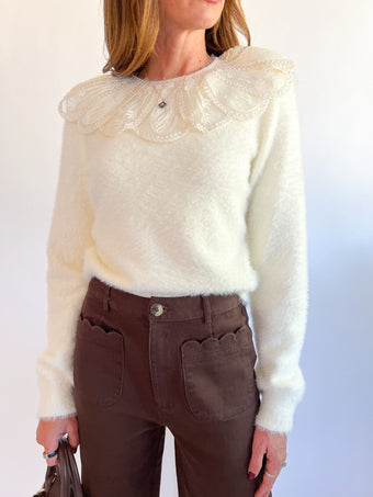 a woman wearing a white sweater