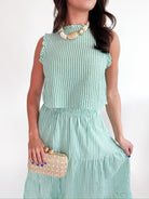 Green striped sleeveless top with ruffle neckline