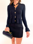 Black long sleeve peplum top with pointelle detailing