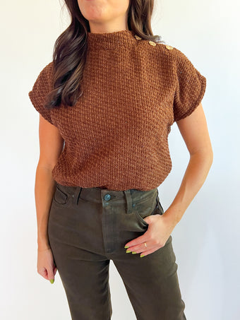 a woman in brown sweater