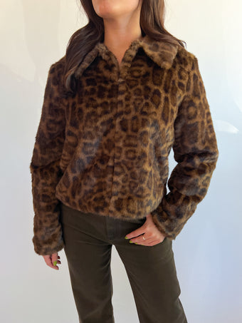 a woman wearing a leopard print shirt