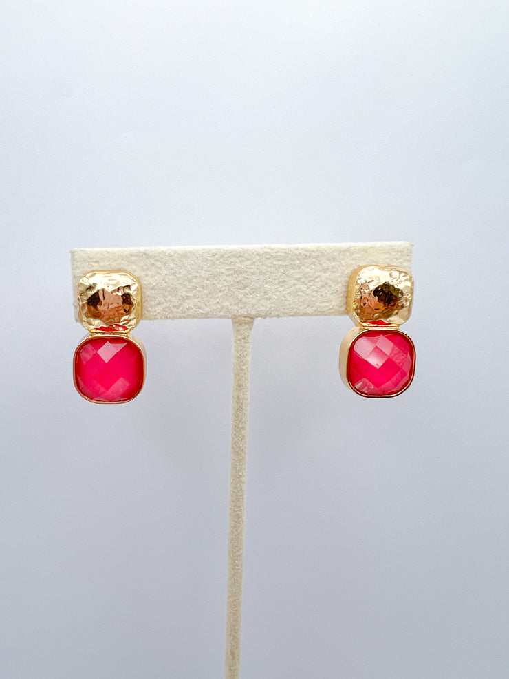a pair of earrings on a stand