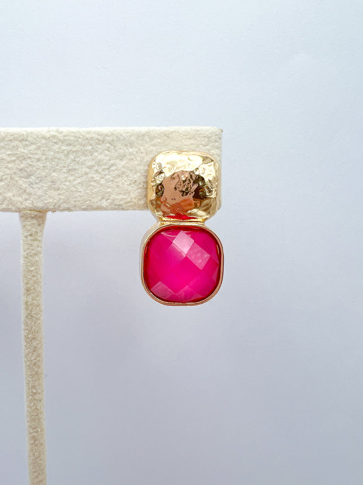 a gold and pink earring