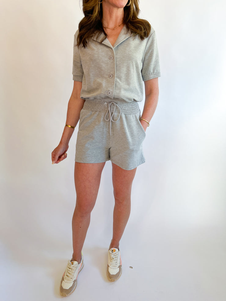 a woman in a grey shirt and shorts