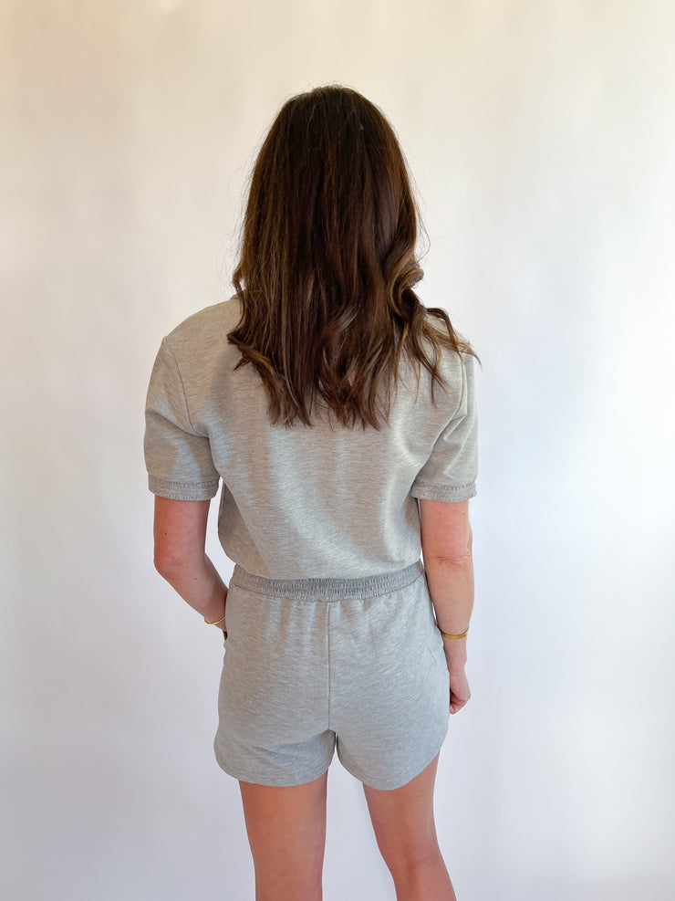 a woman in a grey outfit