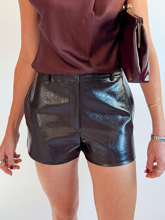 a woman wearing leather shorts