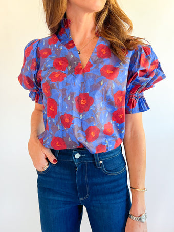 a woman wearing a floral shirt