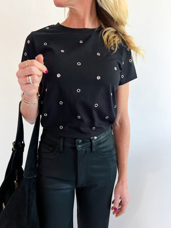 a woman wearing a black shirt and black pants