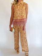 Person wearing a leopard print outfit with a white background