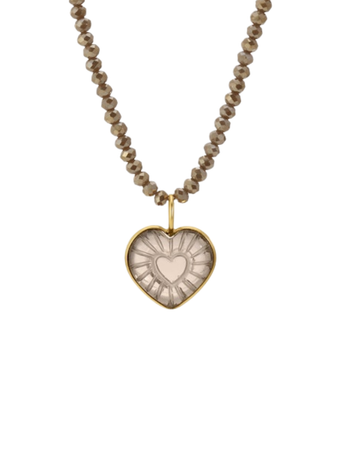 a heart shaped necklace with a gold frame