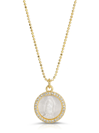a gold necklace with a white medallion