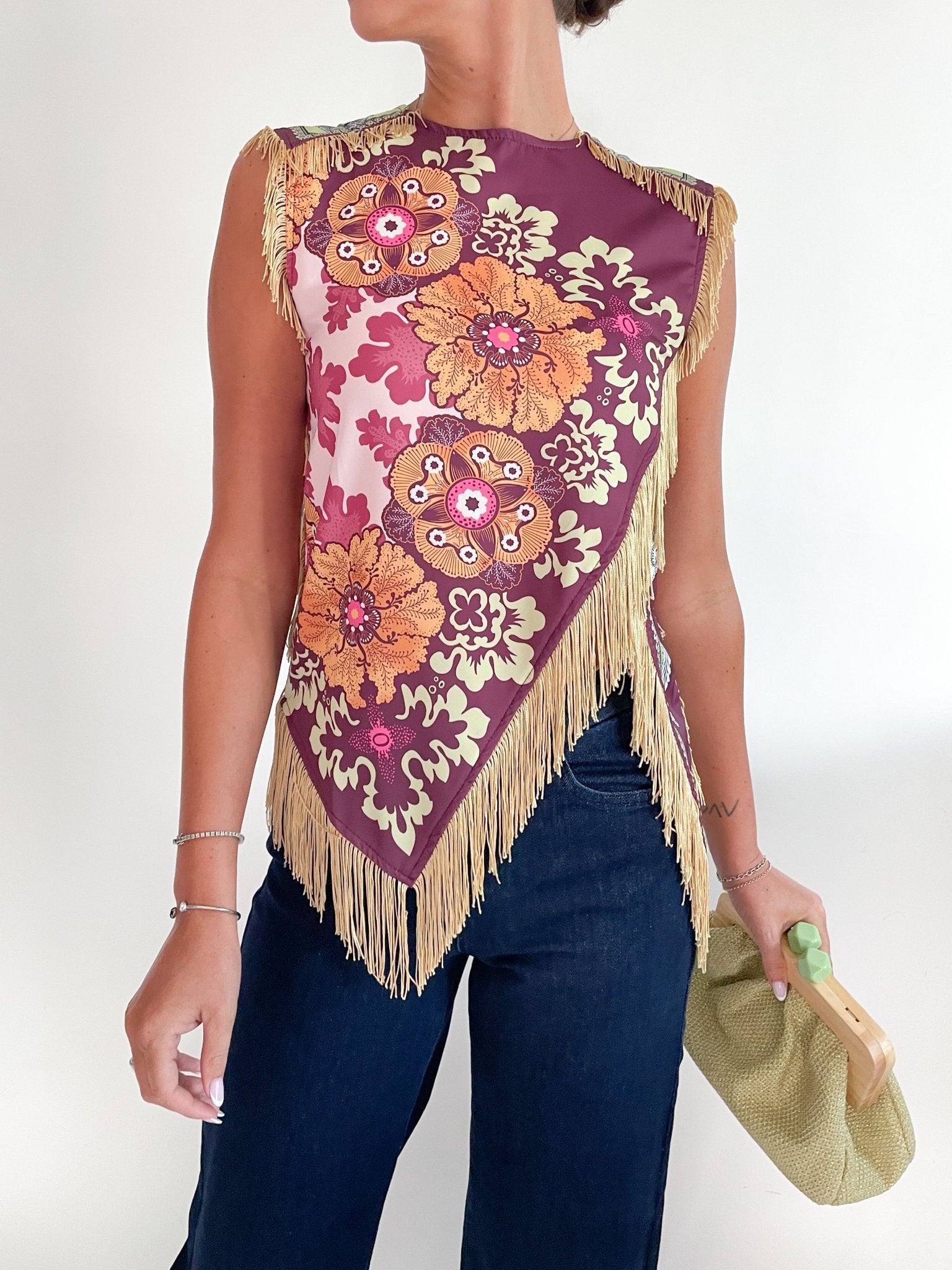 Wine sleeveless top with asymmetrical fringe cross front