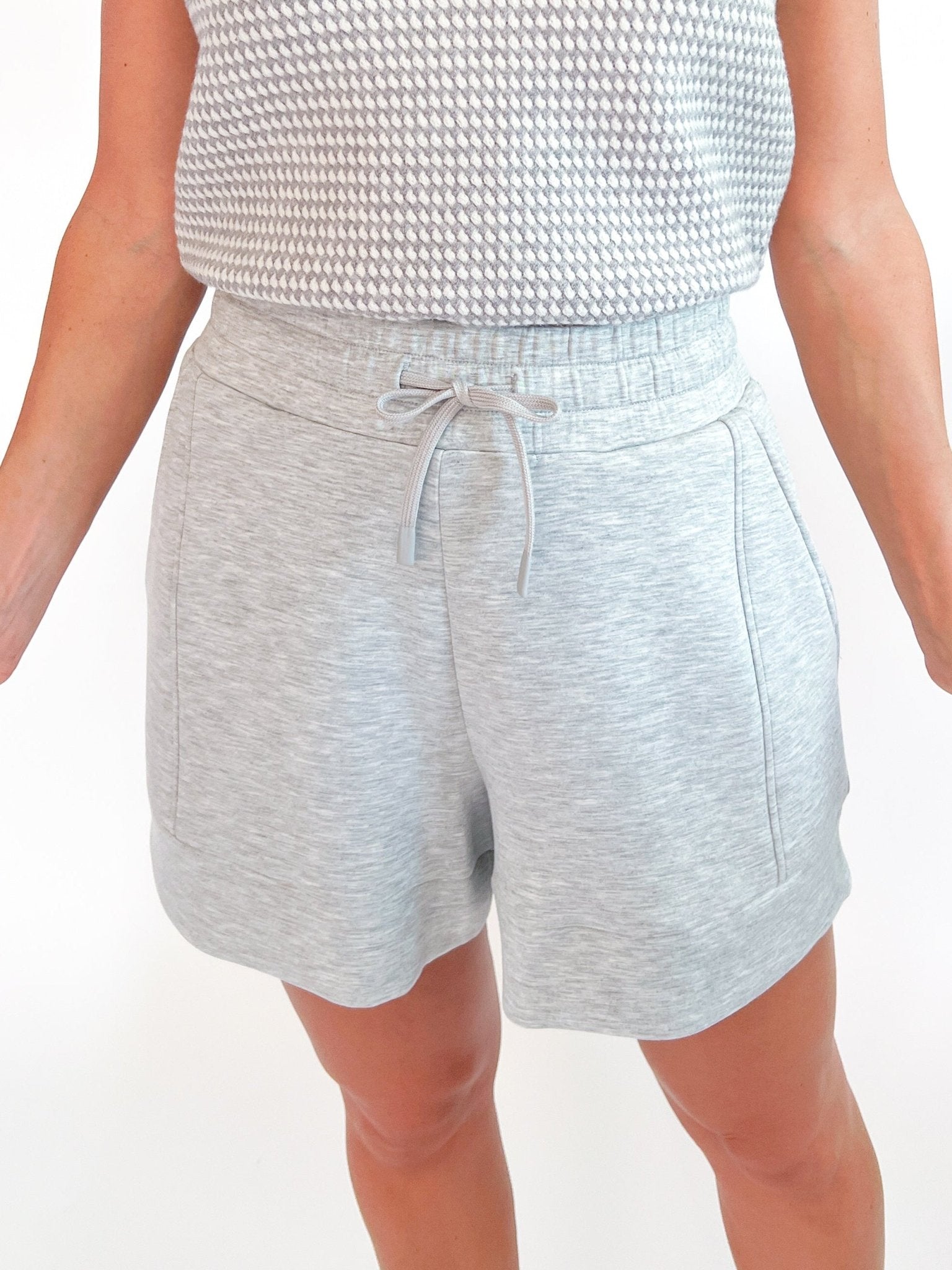 Light grey high rise shorts with A-line silhouette