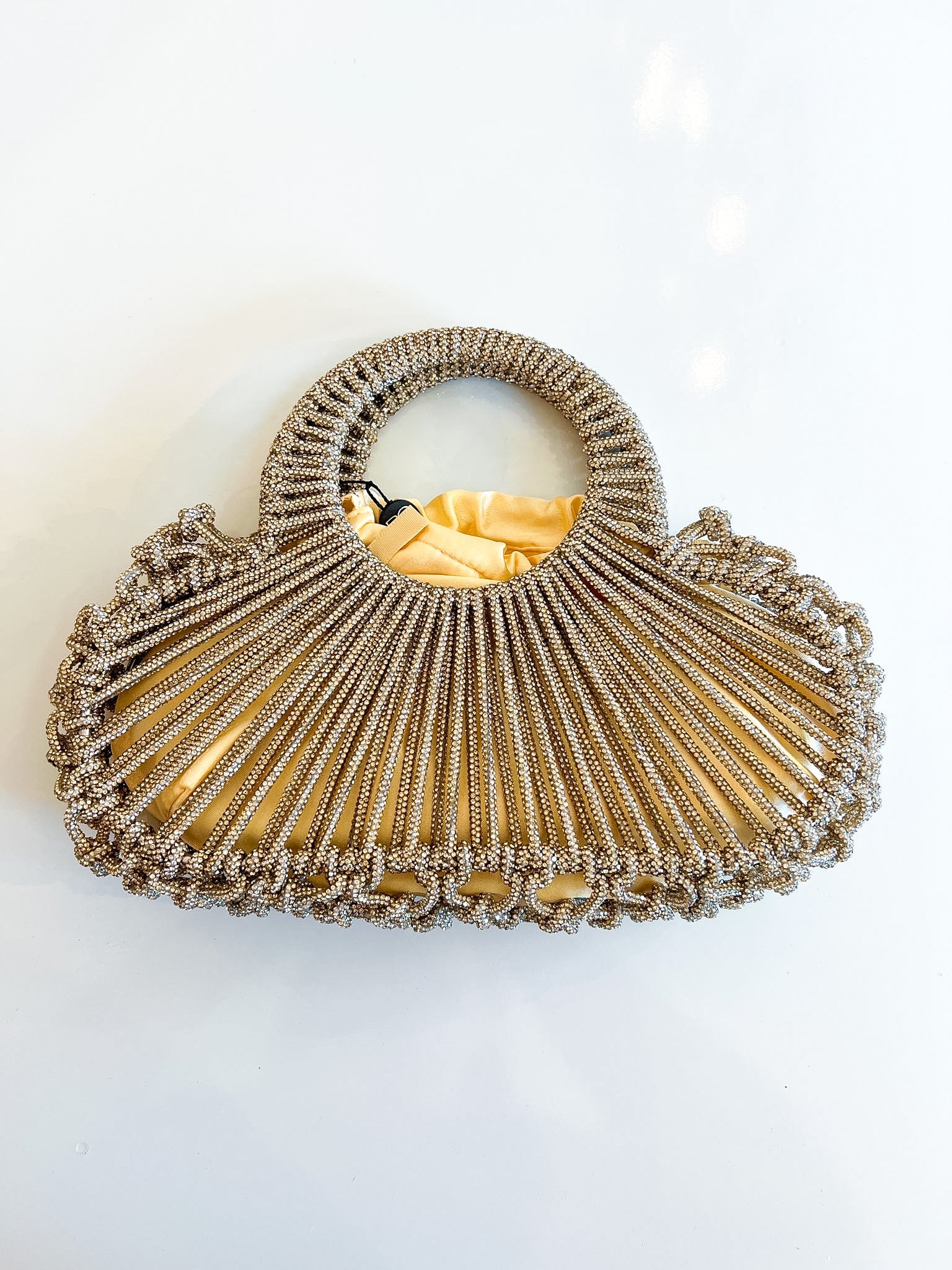 Gold beaded crossbody bag with fan-shaped handle