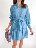 Blue tiered mini dress with long sleeves and tie waist