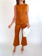 Brown cropped flare pants with stud detailing