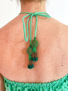Green eyelet embroidered halter top with scalloped trim