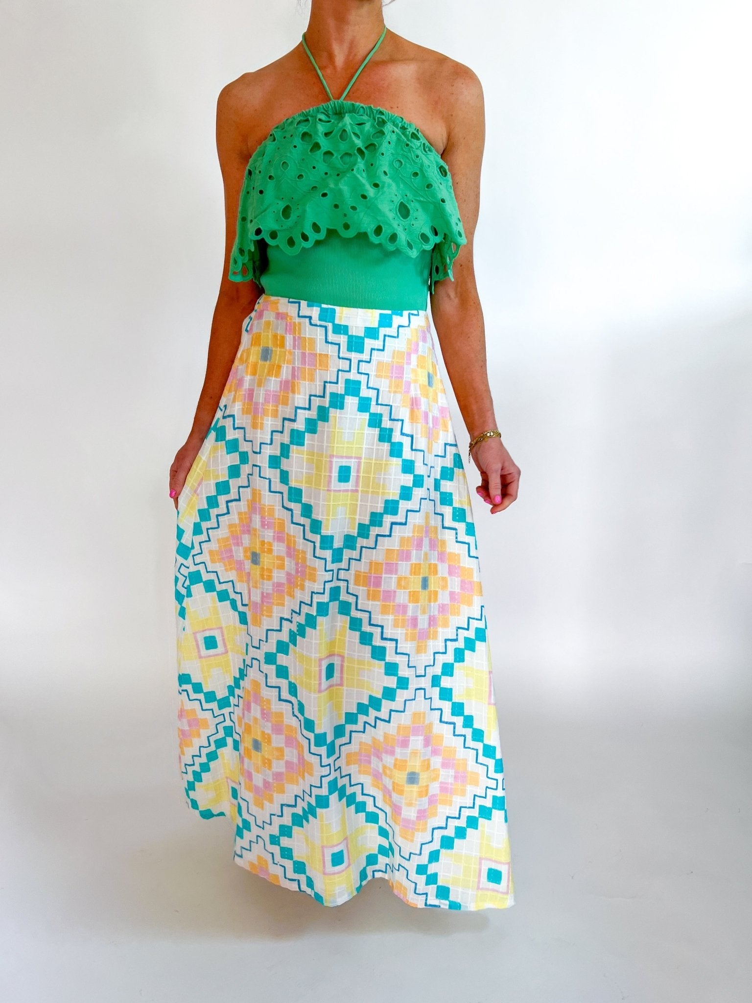 Green eyelet embroidered halter top with scalloped trim