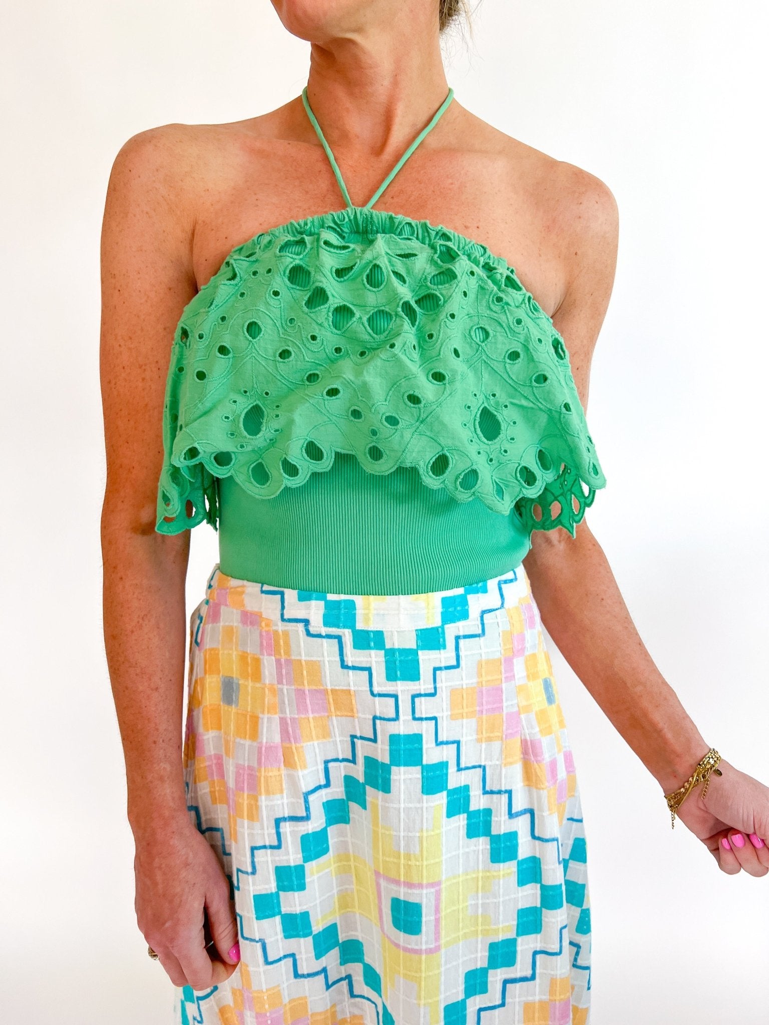 Green eyelet embroidered halter top with scalloped trim