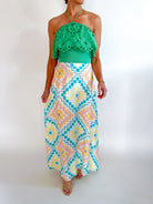 Green eyelet embroidered halter top with scalloped trim
