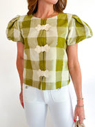 Green gingham top with puff sleeves and open-front bow