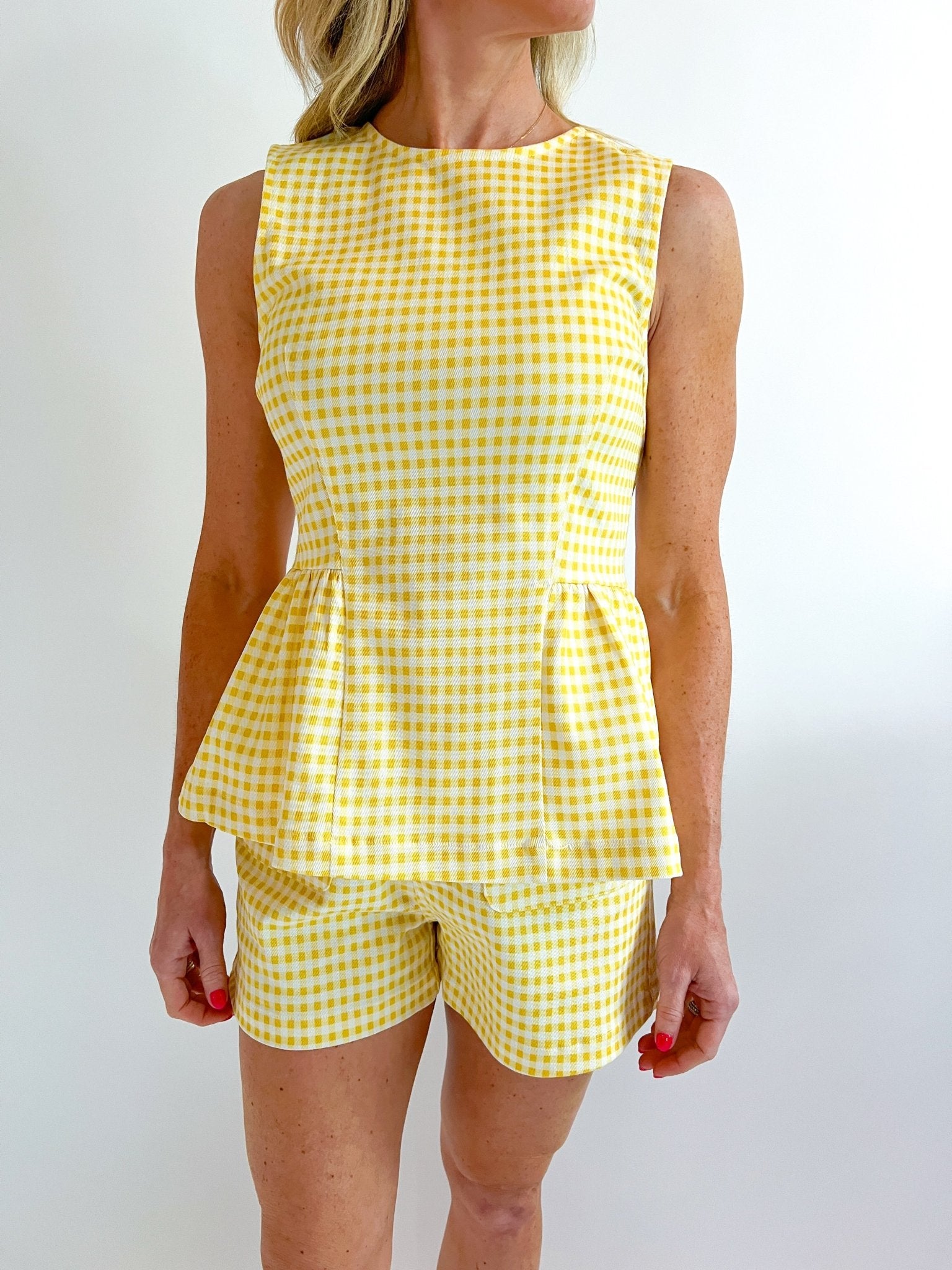 Gold gingham peplum top with structured silhouette