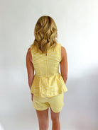 Gold gingham peplum top with structured silhouette