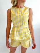 Gold gingham peplum top with structured silhouette