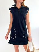 Black sleeveless mini dress with bold grommet accent detailing