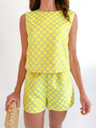 Yellow polka dot sleeveless crop top and matching shorts set