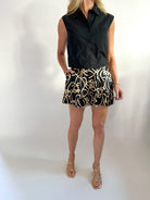 Black sleeveless poplin top with button front
