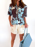 Floral button up blouse with scalloped hem and short sleeves