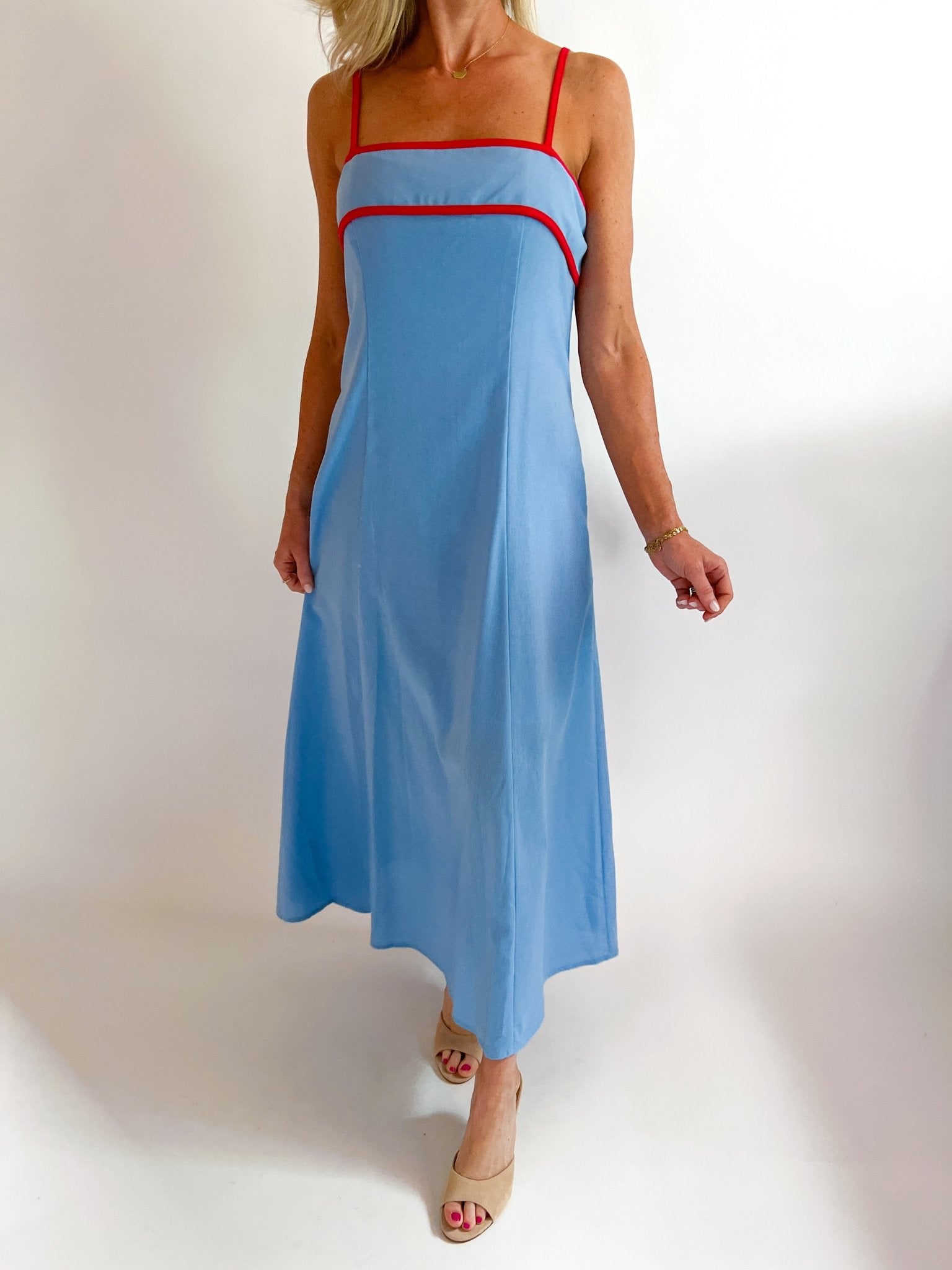 Sky blue sleeveless A-line midi dress with bold contrast trim detail