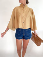 Tan capelet with draped silhouette