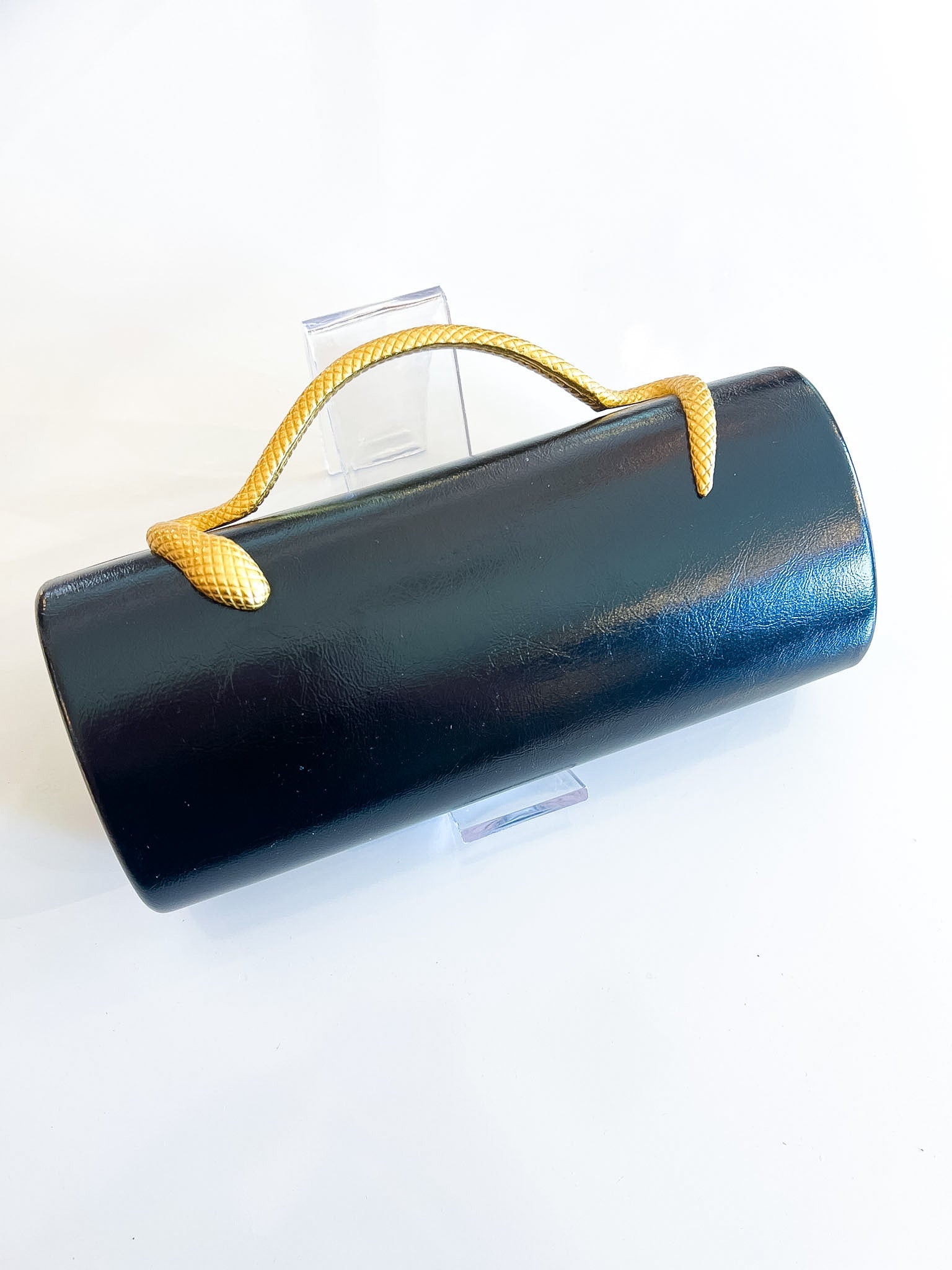 Black leather clutch with sculptural snake handle
