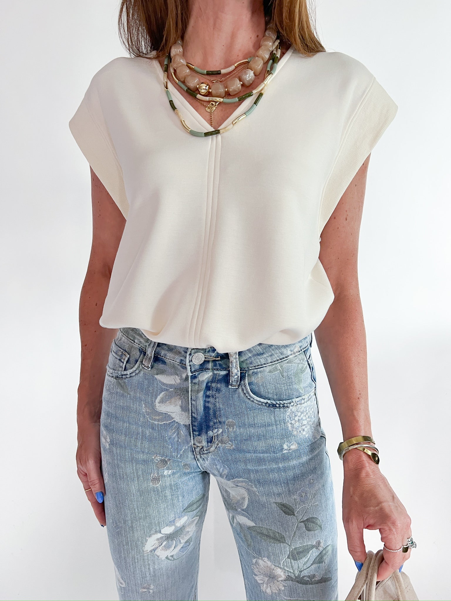 Off-white cap sleeve top with structured silhouette