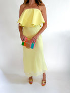 Cream strapless ruffle maxi dress with flowing layered skirt