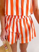 Sunny Stripes Pool Shorts by LIVRO in orange and white cheerful stripe pattern