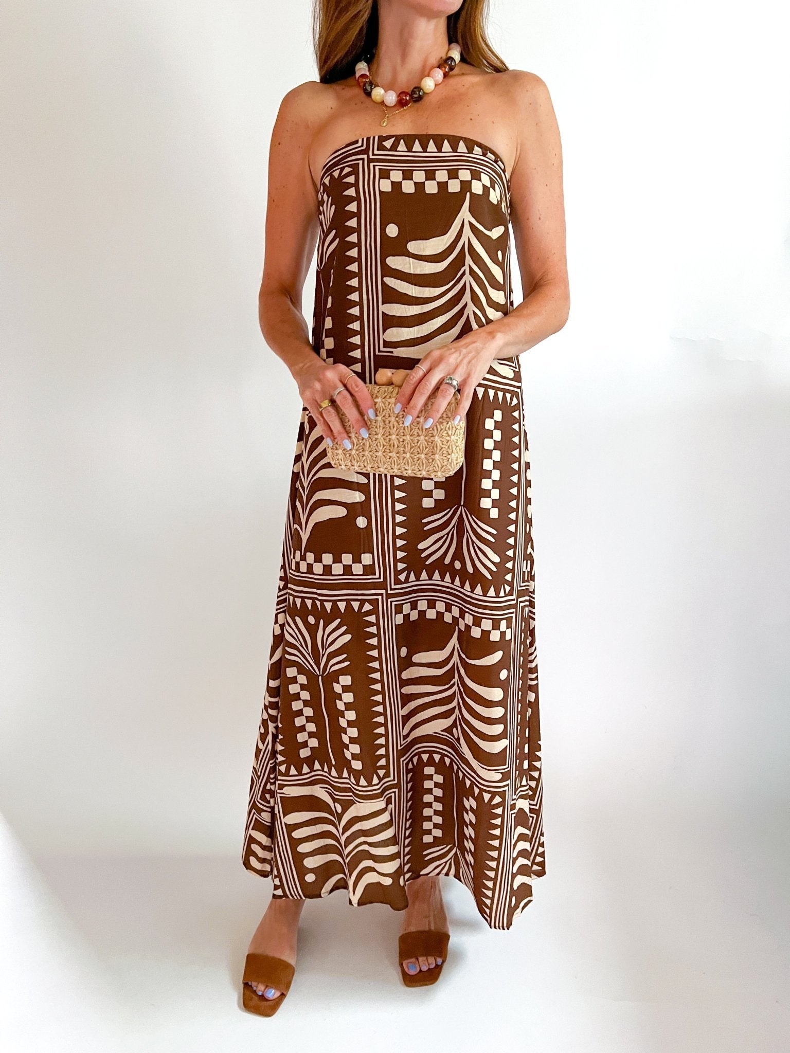 Terracotta maxi dress with strapless neckline and tropical print