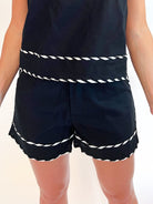 Black tailored shorts with contrast whipstitch trim