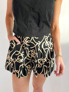 Black pleated high-waisted shorts with flared silhouette