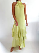 Pistachio green halter maxi gown with elegant formal silhouette